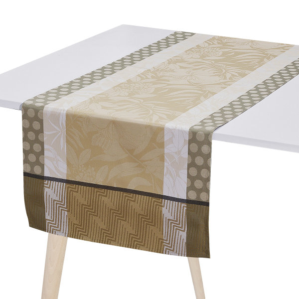 Coated table runner from Le Jacquard Français; Model Nature Urbaine Chene; main colour beige in cotton; Size 50x150 cm rectangular; Motif Flowers and plants; Pattern jacquard woven