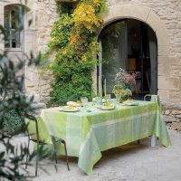Coated tablecloth from Garnier-Thiebaut; Model Mille Dentelles Prairie; main colour green in cotton; Size 175x250 cm rectangular; Motif Flowers and plants, Summer; Pattern jacquard woven