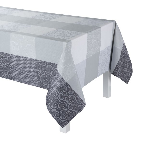 Coated tablecloth from Le Jacquard Français; Model Fleurs De Kyoto Brume; main colour grey in cotton; Size 175x320 cm rectangular; Motif graphic patterns; Pattern jacquard woven