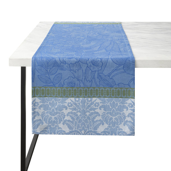 Table runner from Le Jacquard Français; Model Escapade Tropicale Perroquet; main colour blue in linen; Size 50x200 cm rectangular; Motif Flowers and plants; Pattern jacquard woven